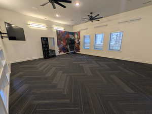 Empty room featuring recessed lighting, ceiling fan, and dark carpet