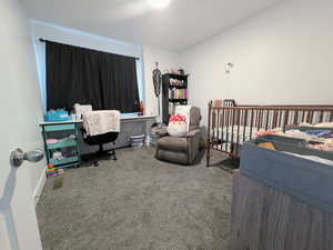 Bedroom featuring carpet floors and baseboards