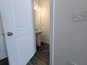Bathroom featuring wood finished floors and baseboards