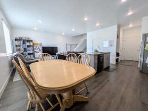 Dining area with stairway, dark wood-style floors, and recessed lighting