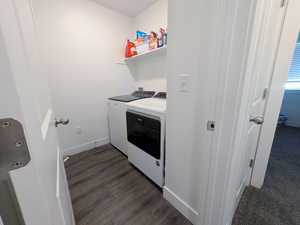 Laundry area featuring washer and clothes dryer and dark wood-style floors