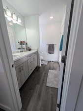 Bathroom featuring vanity and wood finished floors
