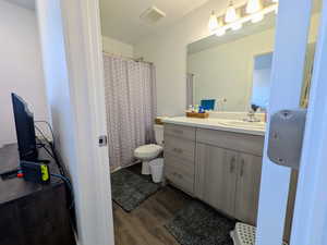 Bathroom featuring vanity and wood finished floors