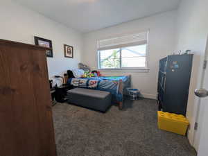Carpeted bedroom with baseboards