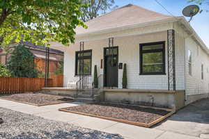 View of front of home featuring a porch and a shingled roof