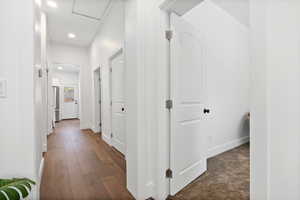 Hallway with recessed lighting and dark wood-style floors