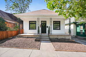 View of front of home featuring a porch, a shingled roof, and shaker shingle siding