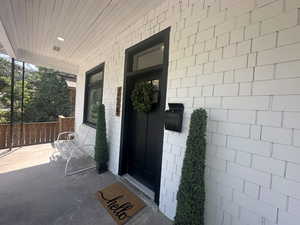 Doorway to property with covered porch