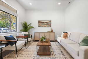 Sitting room with light wood-style flooring and recessed lighting