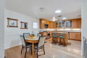 Dining room featuring light wood-type flooring and baseboards