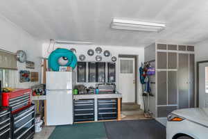 Garage featuring freestanding refrigerator