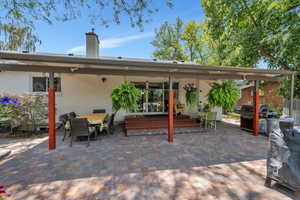 View of patio featuring grilling area and outdoor dining area