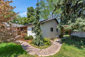 View of home's exterior featuring roof mounted solar panels and brick siding