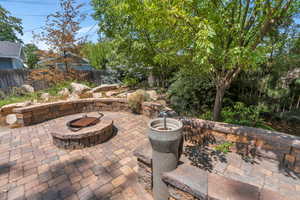 Fenced backyard with an outdoor fire pit and a patio