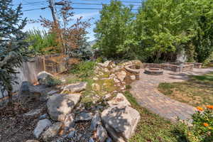 View of yard with an outdoor fire pit