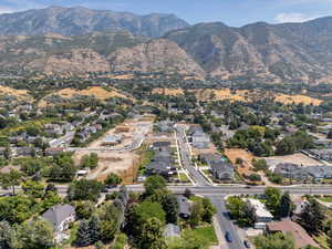 Aerial view of property's location featuring nearby suburban area and a mountainous background