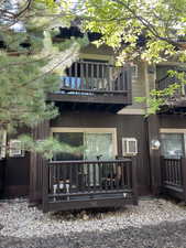 Back of property with a balcony