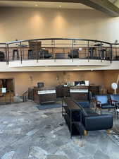 Living area featuring a towering ceiling and stone floors