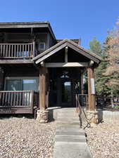 View of exterior entry featuring a balcony