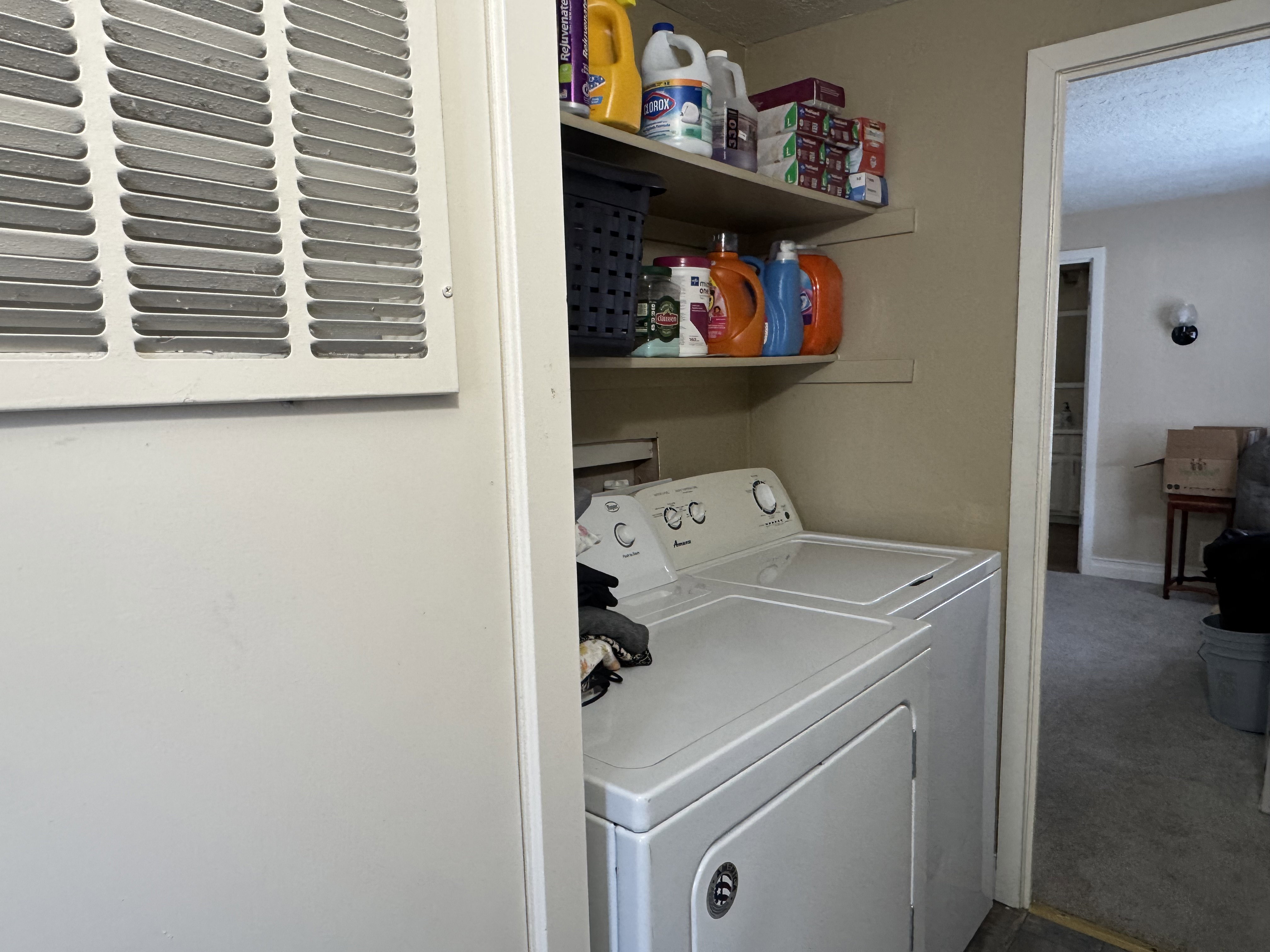 Laundry area with washer and clothes dryer, carpet floors, and a textured ceiling