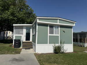 View of front of property featuring a front yard and entry steps