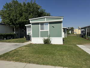 View of side of home featuring a lawn
