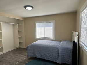 Bedroom featuring wood finished floors and baseboards