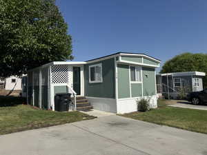 View of front facade featuring a front yard and entry steps