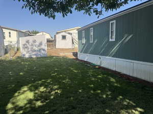 View of yard with a storage unit
