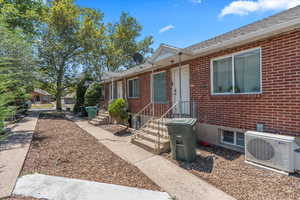 Doorway to property with brick siding