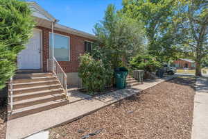 Entrance to property with brick siding