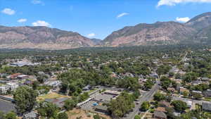 Aerial view of property's location with a mountain backdrop and nearby suburban area