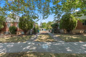 View of home's community with a yard
