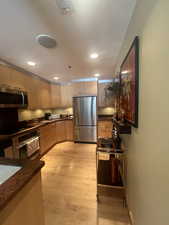 Kitchen with stainless steel appliances, recessed lighting, light wood-type flooring, and light brown cabinetry