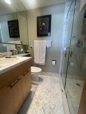 Bathroom featuring vanity and a shower stall