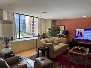 Living area with baseboards and wood finished floors