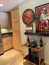 Detailed view of wood finished floors and freestanding refrigerator