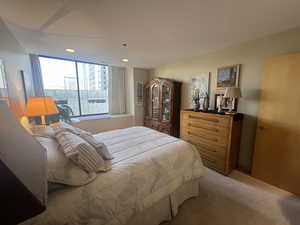 Bedroom with light colored carpet and recessed lighting
