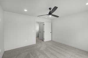Unfurnished bedroom with carpet, recessed lighting, and a ceiling fan