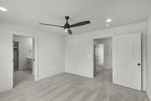Unfurnished bedroom featuring recessed lighting, light colored carpet, and a ceiling fan