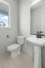 Bathroom with baseboards and tile patterned flooring
