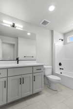 Bathroom featuring vanity, shower / washtub combination, recessed lighting, and tile patterned floors