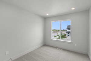Empty room featuring carpet flooring and recessed lighting