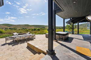 View of patio / terrace featuring outdoor dining area and a mountain view