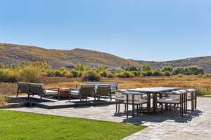 View of patio with a mountain view, outdoor dining area, and an outdoor living space