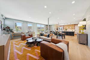 Living room with light wood-style floors and recessed lighting