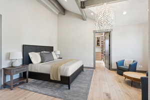 Bedroom with light wood-type flooring, a chandelier, and recessed lighting