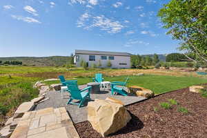 View of patio / terrace featuring an outdoor fire pit