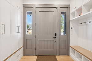 Mudroom with light wood-style floors and plenty of natural light