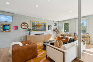 Living area featuring hardwood / wood-style floors and recessed lighting